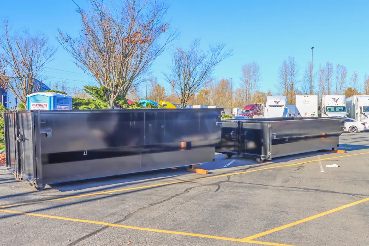 Professional dumpster rental service with roll-off container on residential driveway in Edgartown